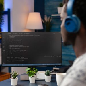 African american young developer wearing headset while typing security codes